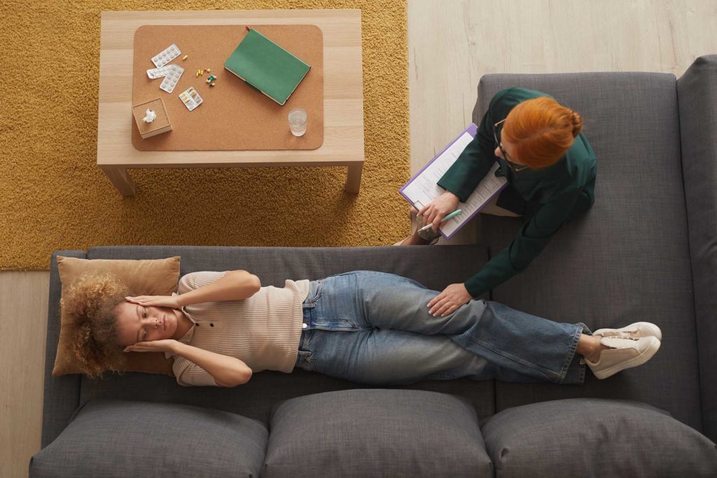Person lying on couch during therapy session